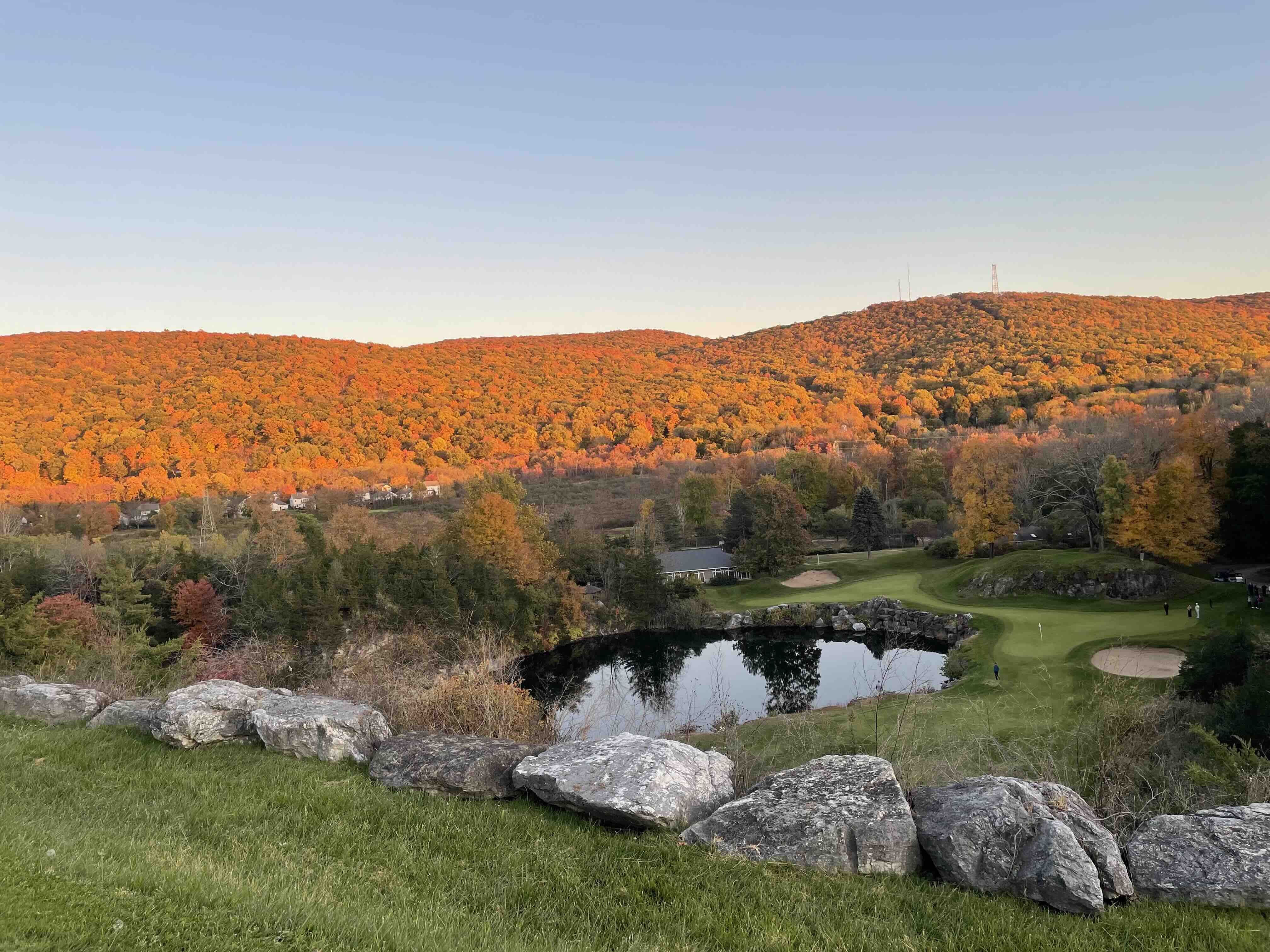 Crystal Springs' par-3 11th hole across the quarry, surrounded by autumn foliage